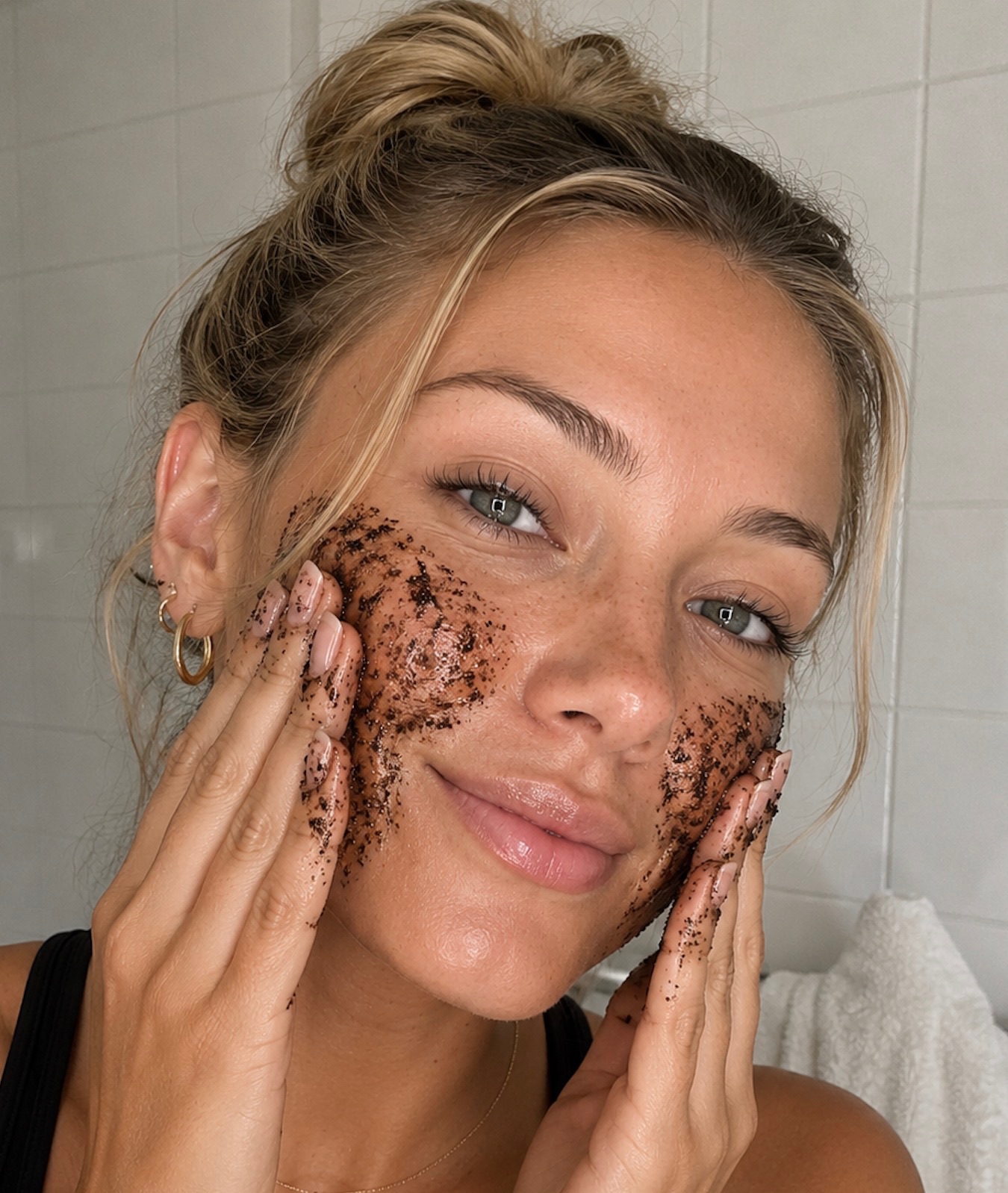 Coffee scrub being massaged over cheeks and jaw