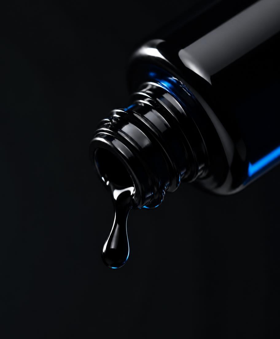 Dropper bottle releasing a bead of ink-black MATTER serum